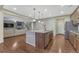 Open kitchen with stainless steel appliances and adjacent living space at 7310 Blue Water Dr, Castle Rock, CO 80108
