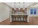 Well-lit kitchen showcases a granite island with seating, wood floors, and stainless steel appliances at 7310 Blue Water Dr, Castle Rock, CO 80108