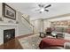 Spacious living room with fireplace, hardwood floors, and stairs, perfect for entertaining at 7310 Blue Water Dr, Castle Rock, CO 80108