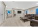 Spacious living room featuring neutral colors, a decorative metal coffee table, and a comfortable leather couch at 7310 Blue Water Dr, Castle Rock, CO 80108