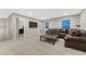 Relaxing living room area with a cozy sofa, carpet flooring, a large window, and a TV at 7310 Blue Water Dr, Castle Rock, CO 80108
