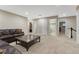 Open living space with a comfortable couch, patterned coffee table, and multiple doorways leading to other rooms at 7310 Blue Water Dr, Castle Rock, CO 80108
