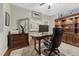 Spacious home office with built in cabinet, large desk, and plush carpet for comfort at 7310 Blue Water Dr, Castle Rock, CO 80108