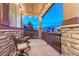 Cozy porch area with stone pillars, seating, and outdoor lighting, perfect for relaxing at 7310 Blue Water Dr, Castle Rock, CO 80108