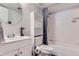 Bathroom features a tub, shower, and a stylish vanity with a round mirror at 12504 E Cornell Ave # 103, Aurora, CO 80014
