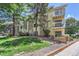 Two-story apartment building with brick accents, multiple balconies, and well maintained lawn with mature landscaping at 12504 E Cornell Ave # 103, Aurora, CO 80014