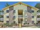 Multi-level apartment building with a light-colored exterior and well-kept landscaping at 12504 E Cornell Ave # 103, Aurora, CO 80014