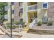 Charming condo building featuring stairs leading to upper units and well-maintained landscaping at 12504 E Cornell Ave # 103, Aurora, CO 80014