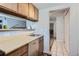 Bright kitchen featuring a stainless steel dishwasher, and view to living area at 12504 E Cornell Ave # 103, Aurora, CO 80014