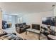 Cozy living room featuring a fireplace, comfortable leather recliners, and sliding glass door to private patio at 12504 E Cornell Ave # 103, Aurora, CO 80014