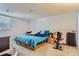 Main bedroom with a large bed, side tables, and ample space for workout equipment at 12504 E Cornell Ave # 103, Aurora, CO 80014