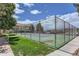 Well-maintained tennis court with a fence and view of surrounding apartment complex at 12504 E Cornell Ave # 103, Aurora, CO 80014