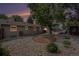 Spacious backyard featuring xeriscaping with rock and a large shade tree, ideal for outdoor living at 3272 S Joplin Ct, Aurora, CO 80013