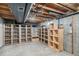 Unfinished basement with wood shelving provides ample storage and organization options at 3272 S Joplin Ct, Aurora, CO 80013