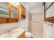 Well-lit bathroom featuring oak cabinets, neutral wall tiles, and a stand-up shower at 3272 S Joplin Ct, Aurora, CO 80013