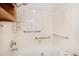 Bright bathroom boasts marble-look walls and shower/tub combo with convenient grab bars at 3272 S Joplin Ct, Aurora, CO 80013