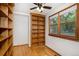 Bedroom with a ceiling fan, hardwood floors, and large wooden bookcase at 3272 S Joplin Ct, Aurora, CO 80013