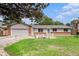 Well-maintained ranch home with a manicured lawn, pretty flower beds, and an attached garage at 3272 S Joplin Ct, Aurora, CO 80013