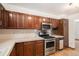 Functional kitchen featuring wood cabinets, stainless steel appliances, and ample counter space at 3272 S Joplin Ct, Aurora, CO 80013