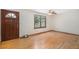 Bright living room featuring gleaming hardwood floors, a ceiling fan, and a large window at 3272 S Joplin Ct, Aurora, CO 80013