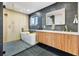 Luxurious bathroom featuring modern tub, glass shower, and wood cabinets with double vanity sinks at 2108 S Hoyt Way, Lakewood, CO 80227