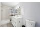 Updated bathroom featuring a modern vanity, shower with tiled walls and a new toilet at 1857 W Tennessee Ave, Denver, CO 80223