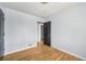 Bedroom with hardwood floors and a view into another room with a door at 1857 W Tennessee Ave, Denver, CO 80223