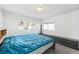 Bright bedroom with natural light, gray carpeting, and dark colored furniture at 1857 W Tennessee Ave, Denver, CO 80223