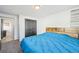 Comfortable bedroom featuring a bed with gray carpeting and dark closet doors at 1857 W Tennessee Ave, Denver, CO 80223