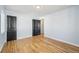 Empty bedroom featuring hardwood floors, light blue walls, and dark doors at 1857 W Tennessee Ave, Denver, CO 80223