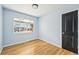 Bedroom with hardwood floors, light blue walls and a window with natural light at 1857 W Tennessee Ave, Denver, CO 80223