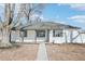 Charming single-story home with white siding, black trim, and a well-maintained front yard at 1857 W Tennessee Ave, Denver, CO 80223