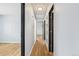 Hallway with hardwood floors and multiple doors at 1857 W Tennessee Ave, Denver, CO 80223