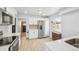 Modern kitchen with stainless steel appliances, white cabinets, and natural lighting at 1857 W Tennessee Ave, Denver, CO 80223