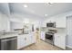 Modern kitchen with stainless steel appliances, white cabinets, and tile backsplash at 1857 W Tennessee Ave, Denver, CO 80223