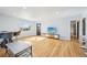 Bright living room with hardwood floors, modern furniture, and abundant natural light at 1857 W Tennessee Ave, Denver, CO 80223