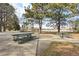 Picnic tables and mature trees by the lake provide a relaxing spot to enjoy the view at 1857 W Tennessee Ave, Denver, CO 80223