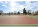 Outdoor tennis court surrounded by mature trees, perfect for recreational play at 1857 W Tennessee Ave, Denver, CO 80223