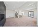 Spacious basement featuring neutral carpet, modern fireplace, and wet bar at 5741 Doc Bar Circle, Larkspur, CO 80118