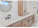 Modern bathroom featuring white countertops and wood cabinets, plus matte black fixtures at 5741 Doc Bar Circle, Larkspur, CO 80118