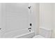 Bathroom features white tile, modern fixtures, and shower over tub at 5741 Doc Bar Circle, Larkspur, CO 80118