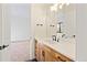 Bathroom vanity with wood cabinets, white countertop and bronze fixtures at 5741 Doc Bar Circle, Larkspur, CO 80118