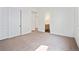 Neutral-colored bedroom with closet and doorway to the ensuite bath at 5741 Doc Bar Circle, Larkspur, CO 80118