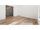 Bedroom with brick accent wall and hardwood floors at 5741 Doc Bar Circle, Larkspur, CO 80118