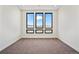 Bedroom features large picture windows and carpet at 5741 Doc Bar Circle, Larkspur, CO 80118