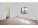 Bright, neutral-colored bedroom with window and doorway with ensuite bath at 5741 Doc Bar Circle, Larkspur, CO 80118