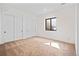 Bright bedroom with neutral carpet, window, and closet doors at 5741 Doc Bar Circle, Larkspur, CO 80118