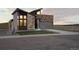 Modern home featuring stone accents, a gray garage door, and professionally landscaped front yard at 5741 Doc Bar Circle, Larkspur, CO 80118