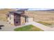 A modern home with stone and siding, a two-car garage, a concrete driveway, and a well-manicured lawn at 5741 Doc Bar Circle, Larkspur, CO 80118