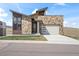 Modern two-story home boasts stone accents, a two-car garage, and a professionally landscaped front yard at 5741 Doc Bar Circle, Larkspur, CO 80118